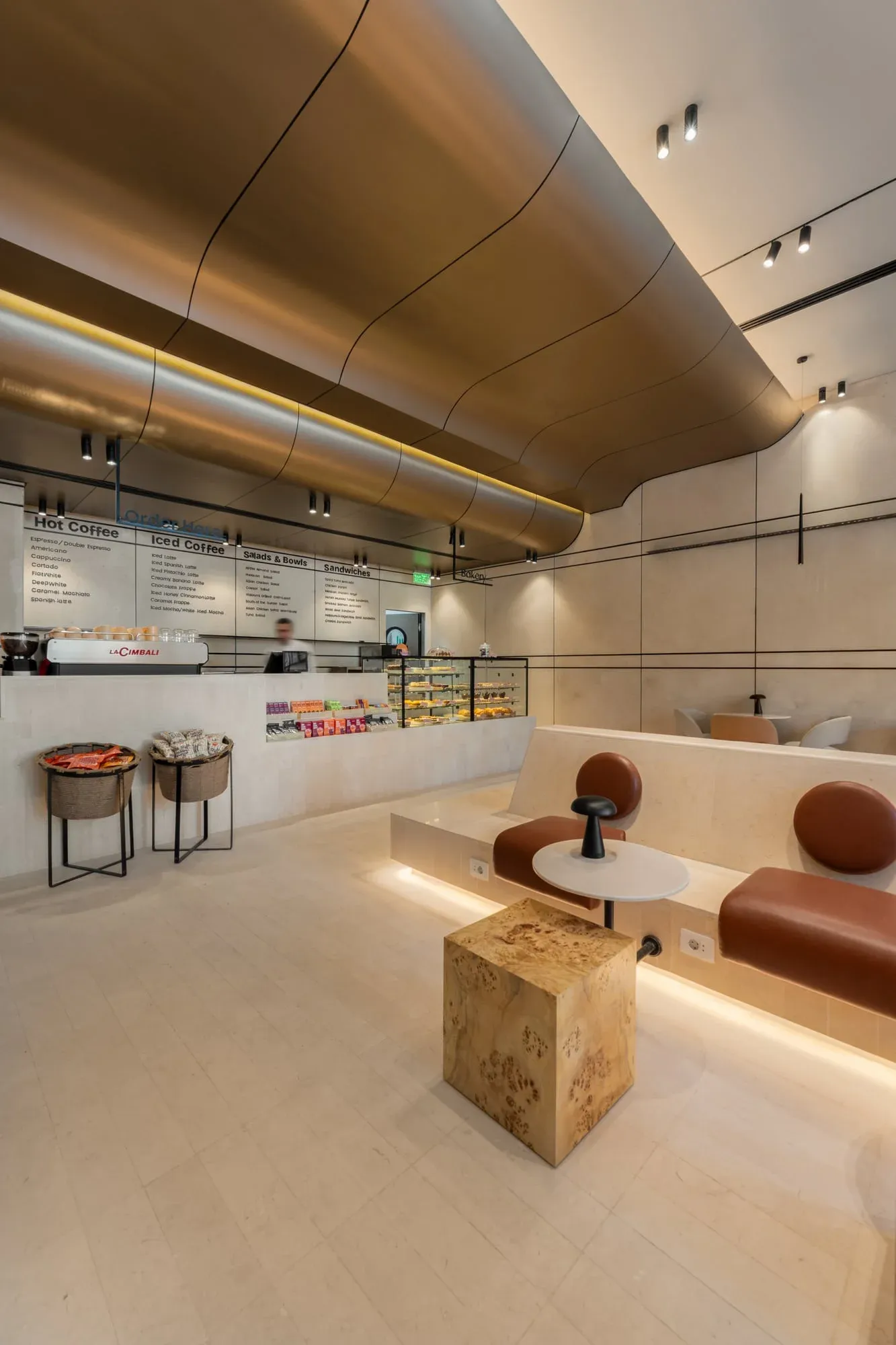 Wide angle view of café showing curved ceiling and seating arrangement