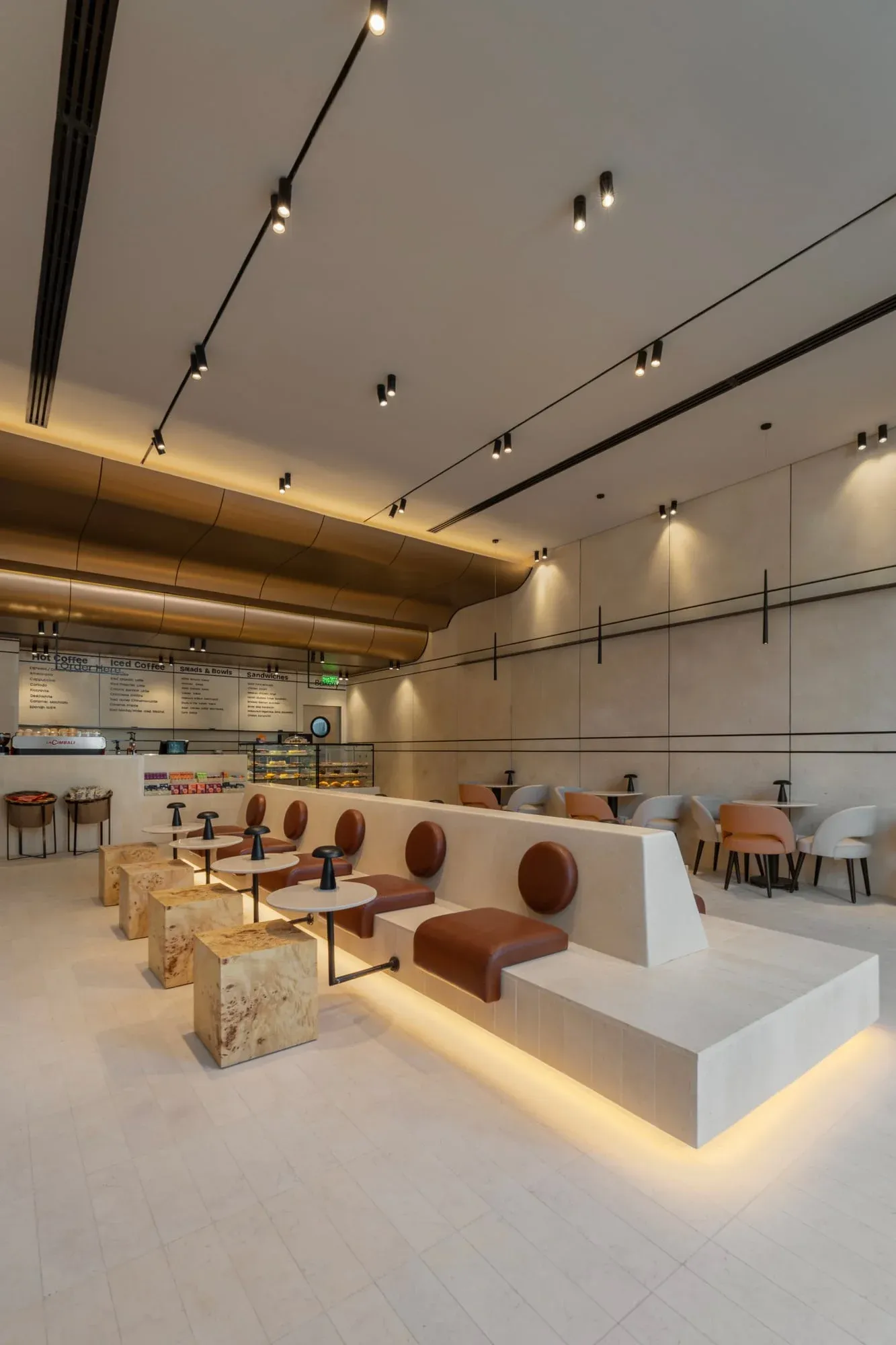 Close-up of curved ceiling showing HPL stainless steel finish and lighting grooves