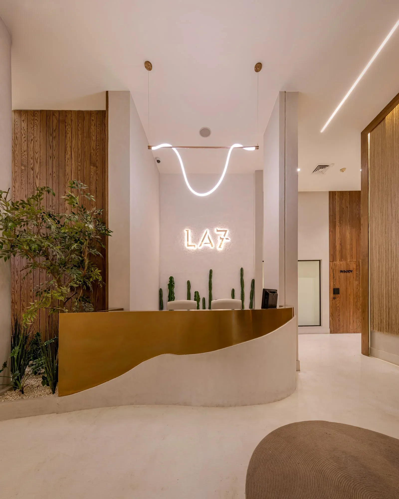 Logo wall detail showing engraved lighting effects and shelving integration