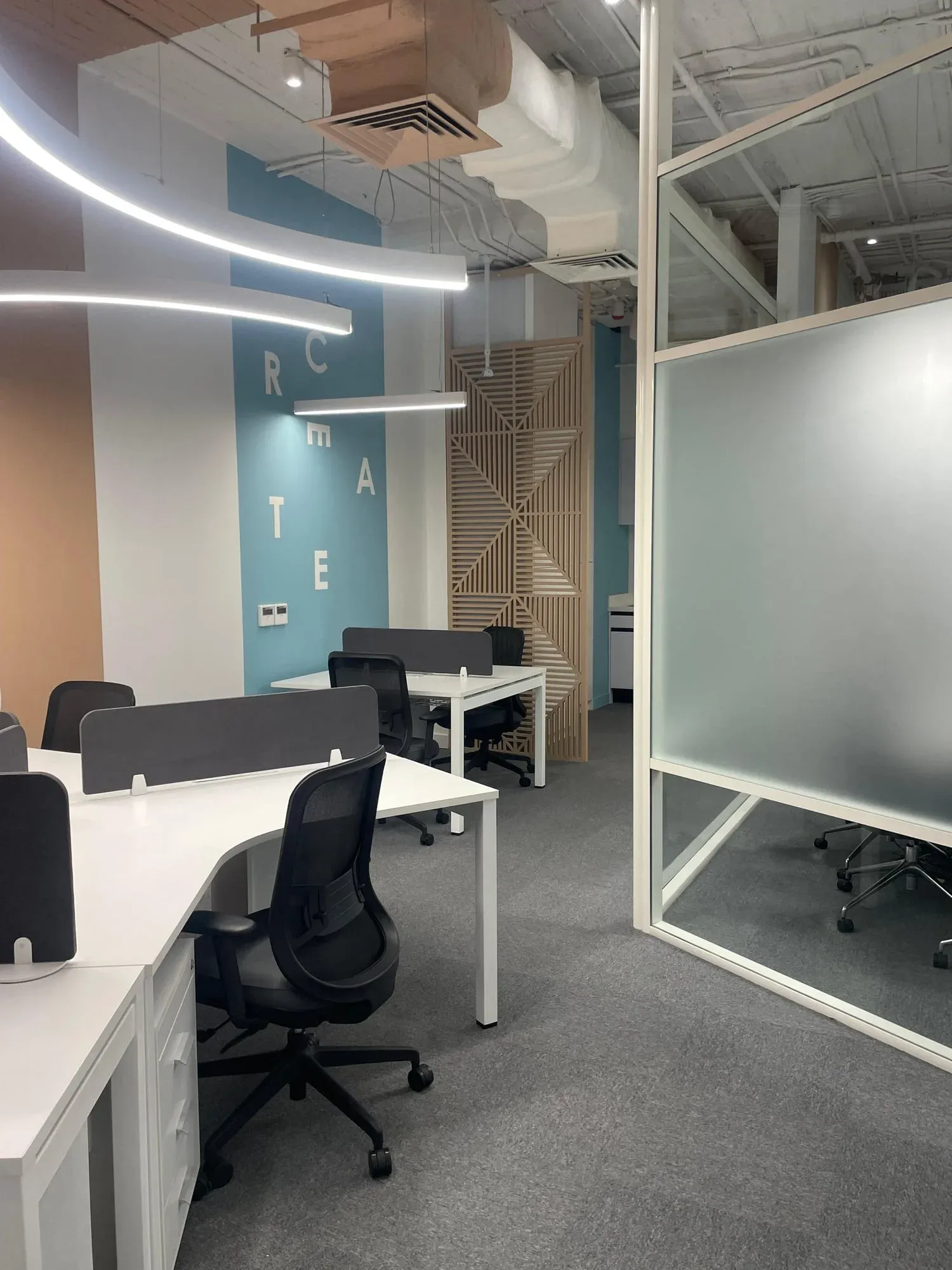 Overall office view showing floor-to-ceiling cabinets and professional finishes