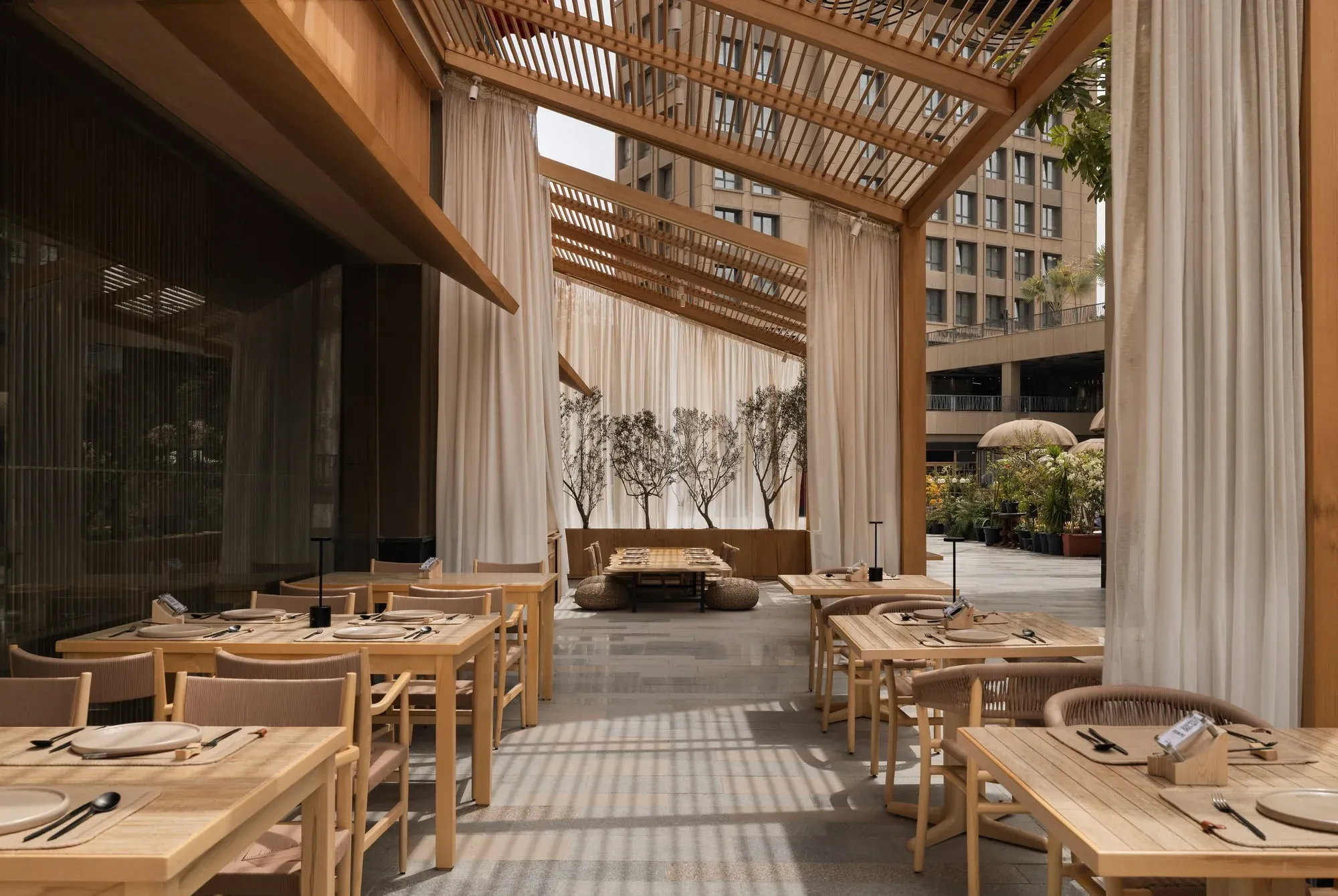 Overall restaurant view showing outdoor pergolas and facade